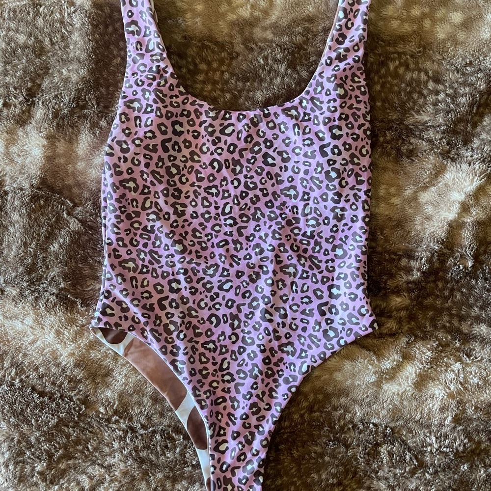 Reversible Moana one piece suit in size medium.